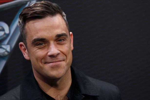 Birthday boy Robbie Williams poses naked to show impressive six pack